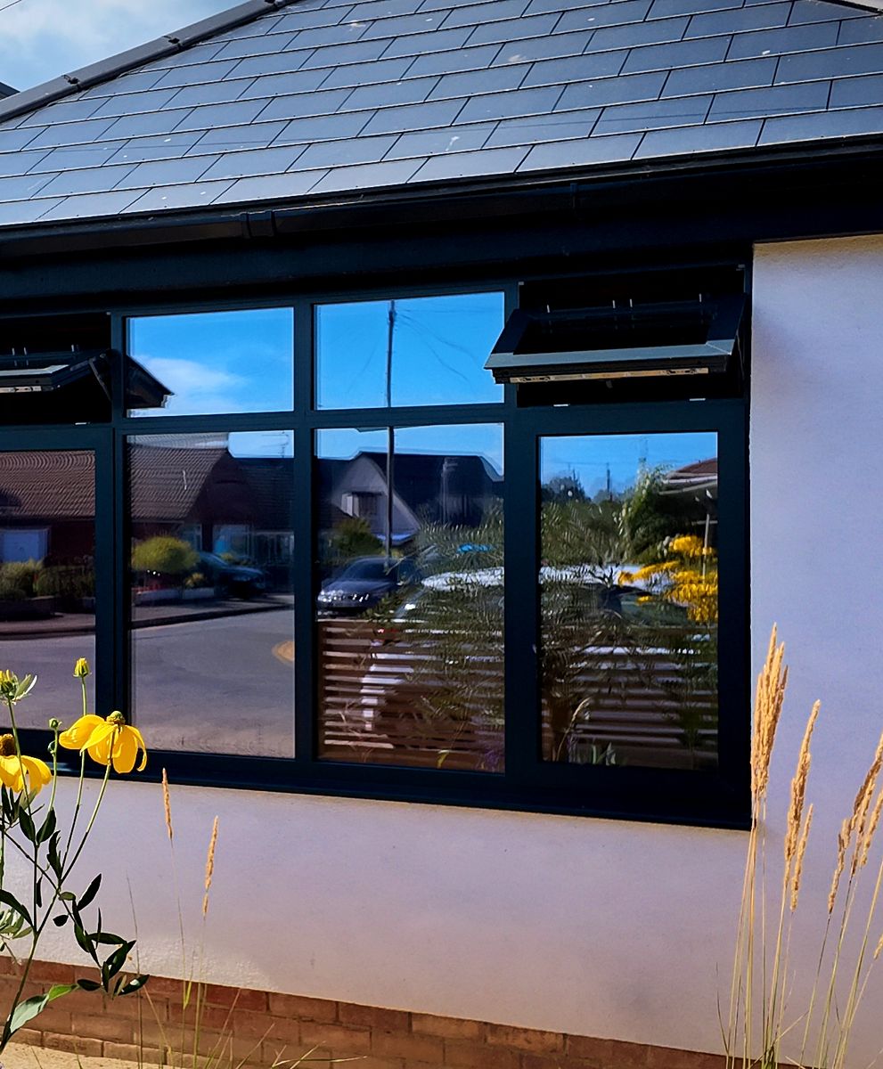 Rendered front elevation with anthracite windows and planting