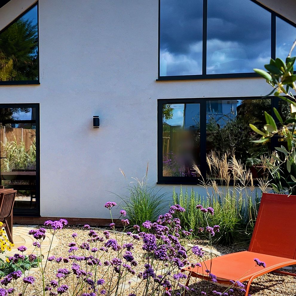Rear elevation with large glazing and a planted garden