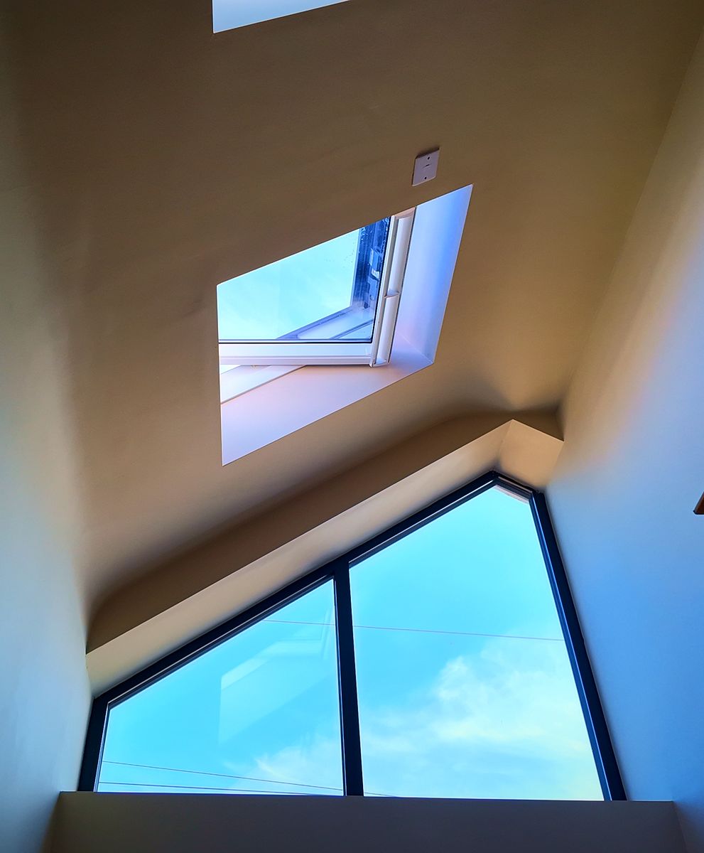 Room in the roof with a glazed gable window and rooflight