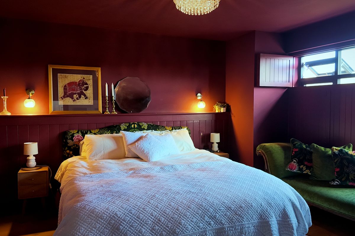 Bedroom with panelled feature wall and wall lights