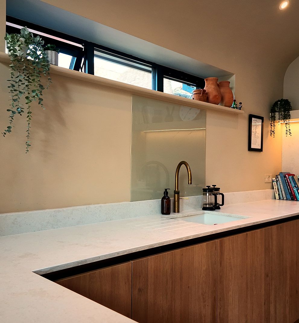 Kitchen with white worktops and wood-effect units
