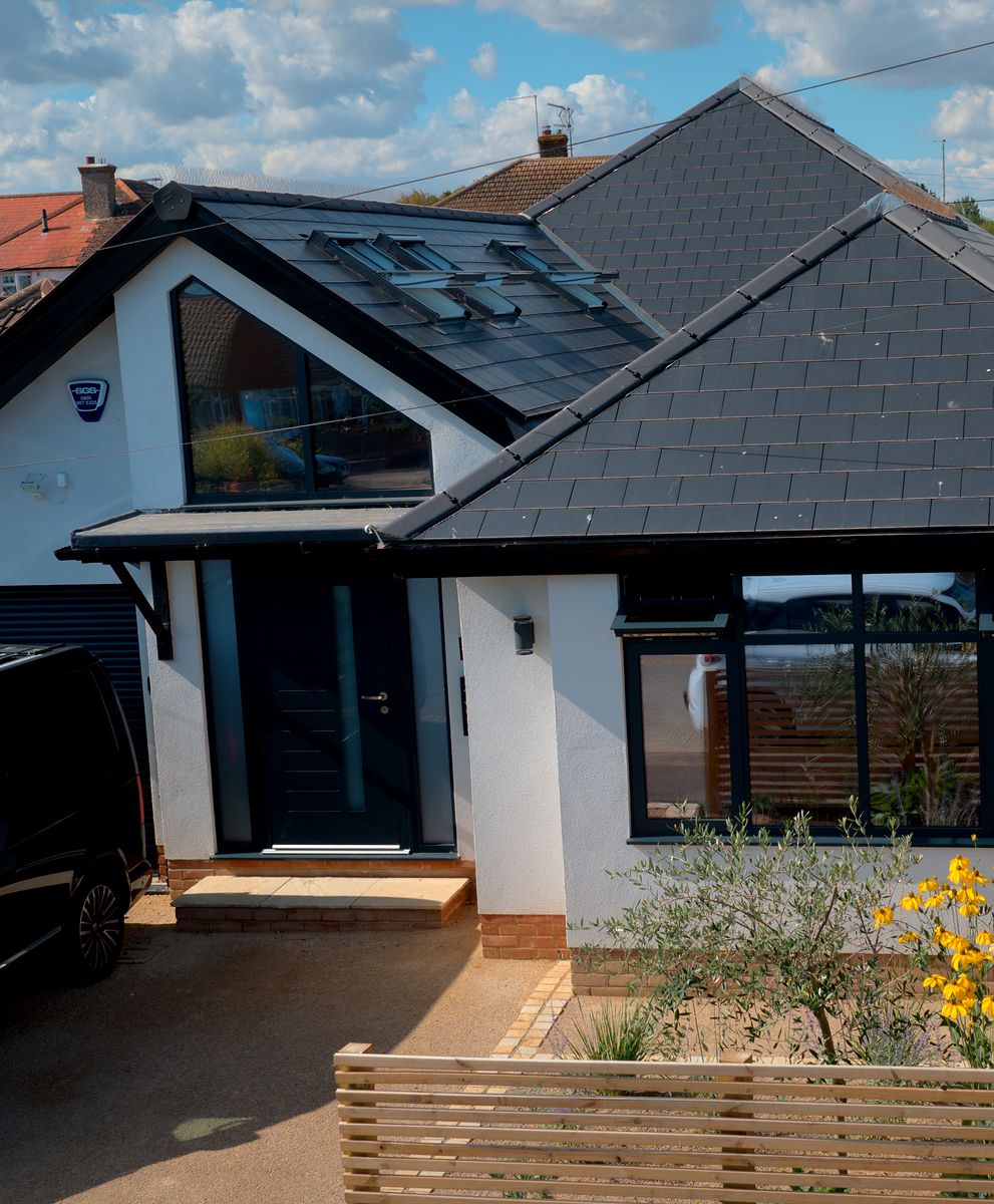 Renovated home with white render, glazed gable and anthracite windows