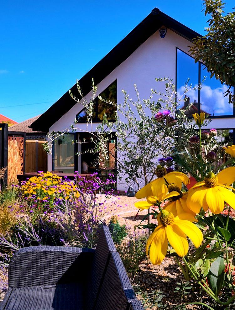 Seafield Road home renovation, with the glazed gable behind summer flowers