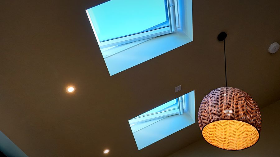 Rooflights and a woven pendant light in a vaulted ceiling
