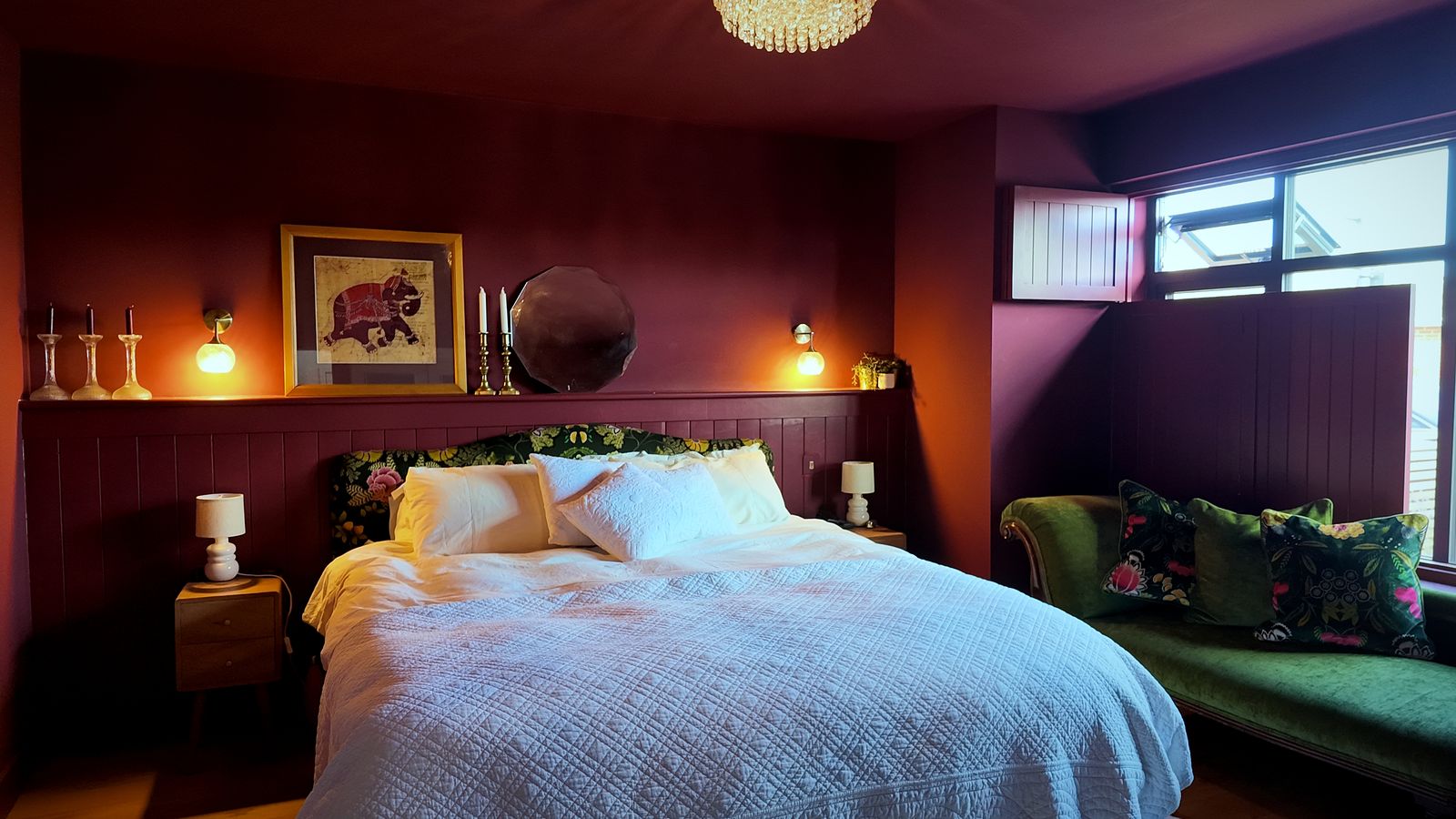Bedroom with a panelled feature wall and wall lights