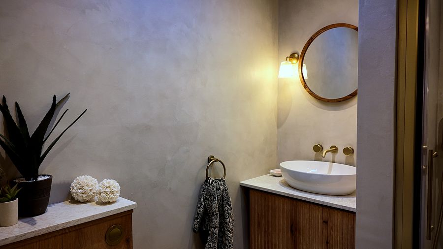 Bathroom with plaster-finish walls and a countertop basin