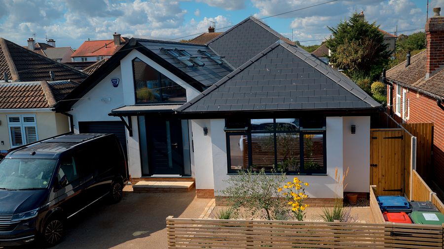 Front of the house with its new grey roof and planted front garden