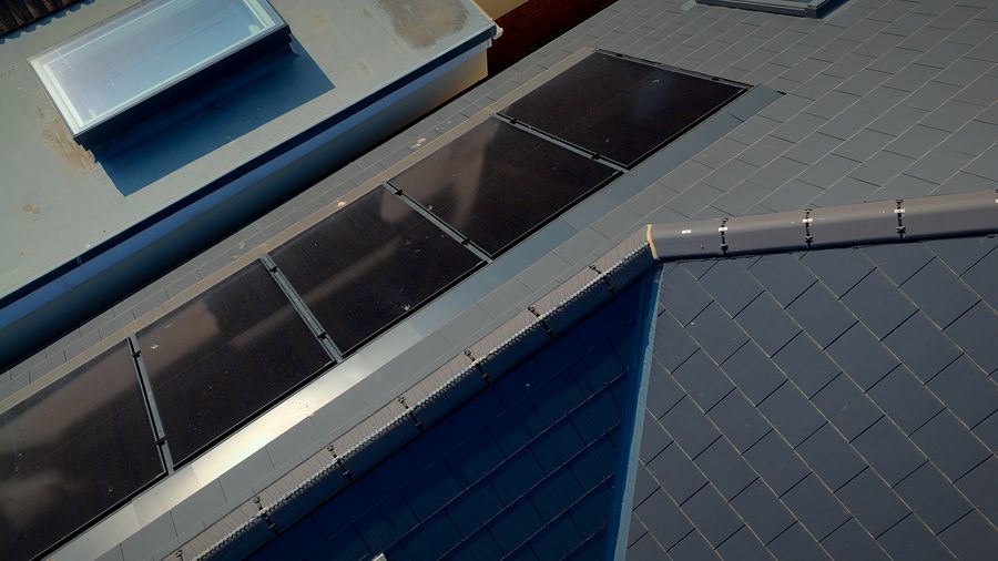 In-roof solar panels and a flat-roof rooflight
