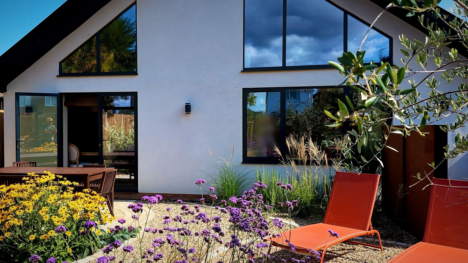 Rear elevation with large glazing and a planted gravel garden