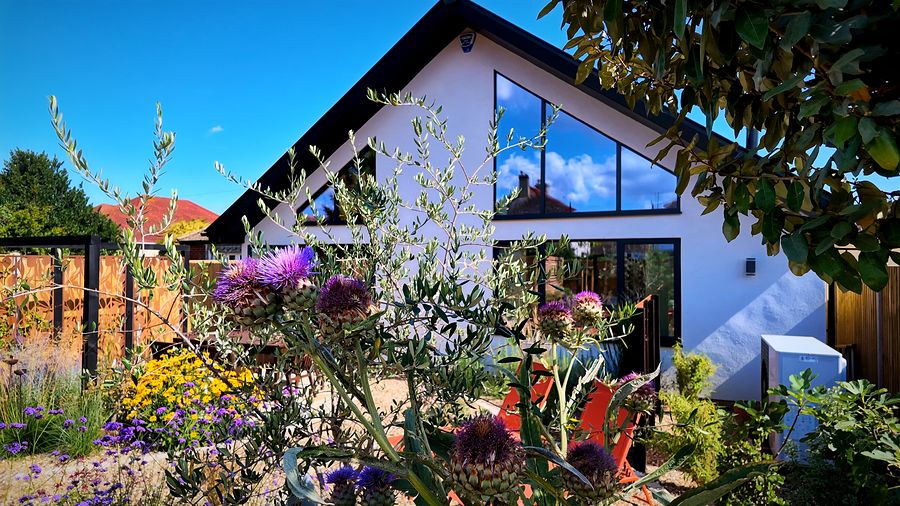 Glazed gable seen through the garden planting