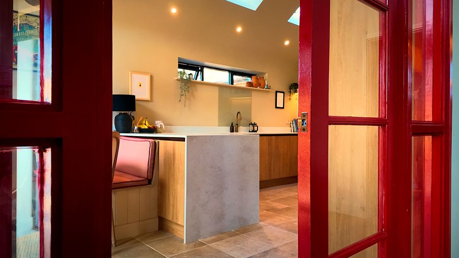 Red glazed internal doors opening onto the kitchen